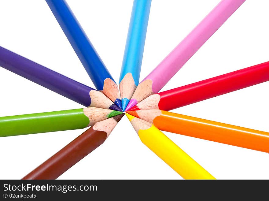 Nine different colored pencils in circle on white background, triangular shaped for correct pencil grip