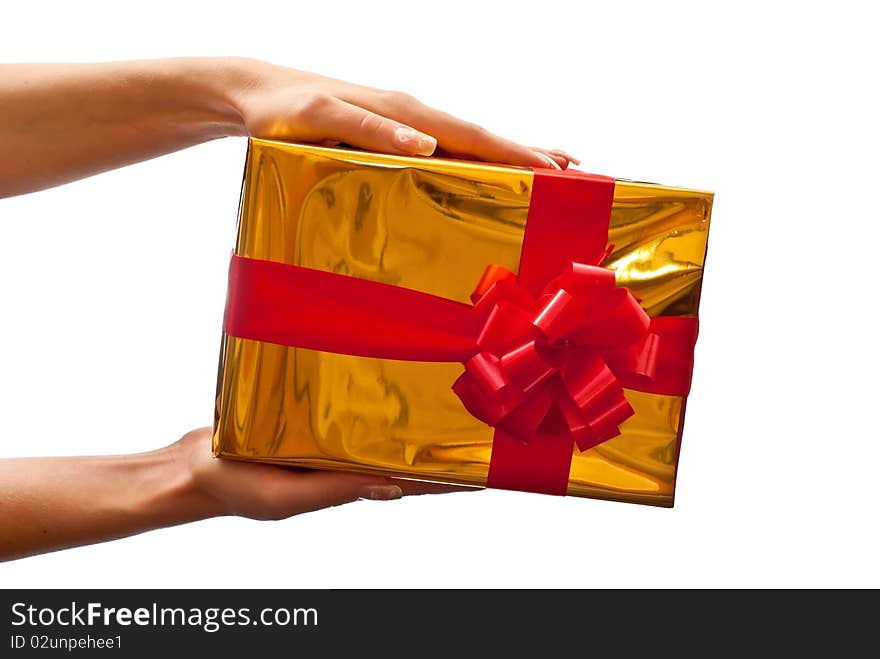 Woman's hands with yellow gift box and red bow isolated on white background. Woman's hands with yellow gift box and red bow isolated on white background