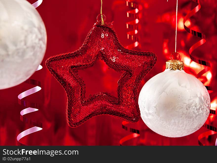 Beautiful christmas star and white baubles. Focus on star