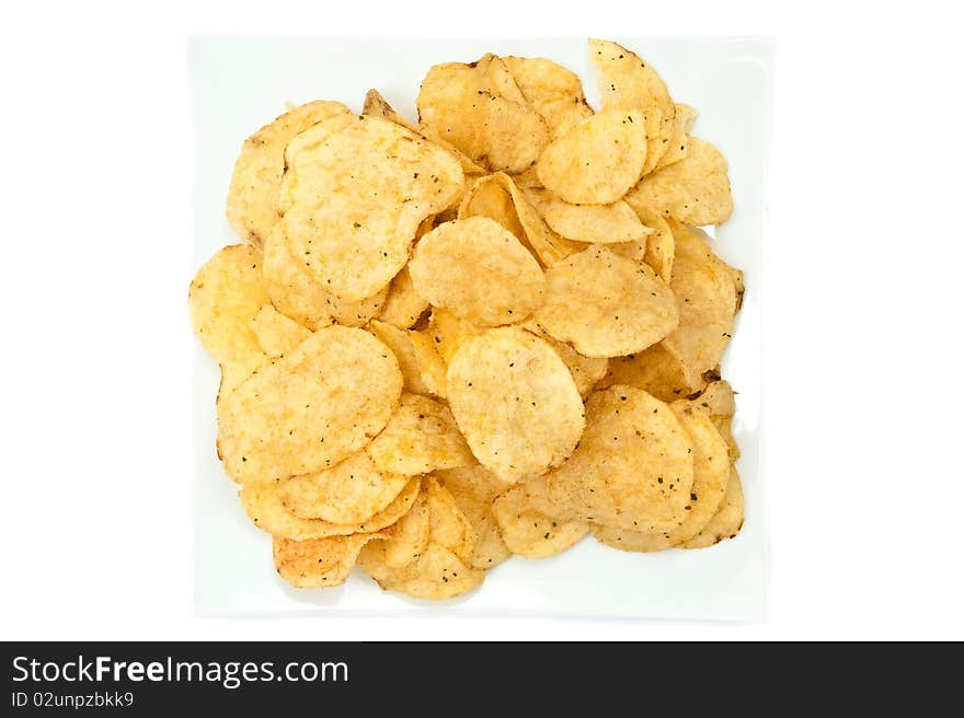 Heap of chips on plate isolated on white background