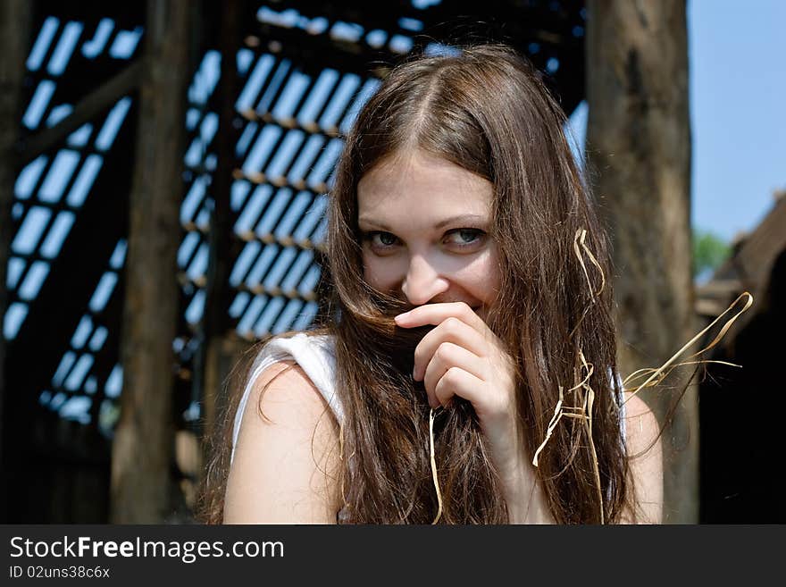 Close-up of young woman with straw in hair