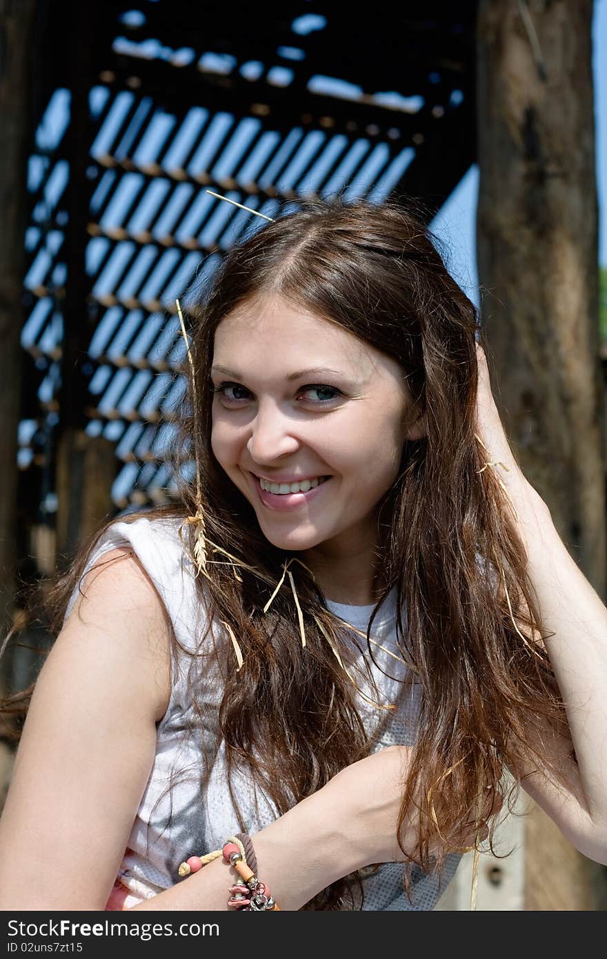 Close-up of young woman with straw in hair