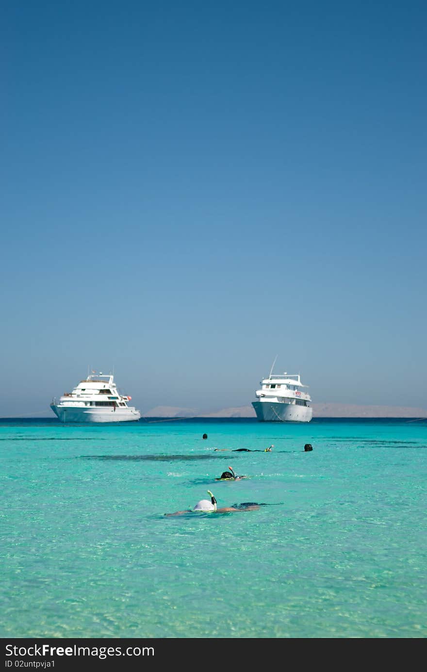 Snorkeling in a lagoon on a tropical island. Escape to a tropical paradise travel destination. Snorkeling in a lagoon on a tropical island. Escape to a tropical paradise travel destination.