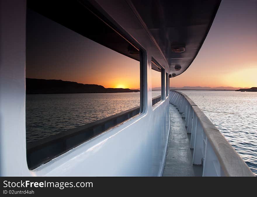 Sunset over the sea reflected in the windows of a boat. Sunset over the sea reflected in the windows of a boat