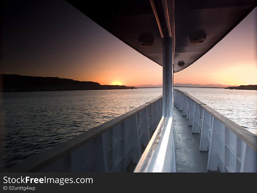 Sunset over the sea reflected in the windows of a boat. Sunset over the sea reflected in the windows of a boat