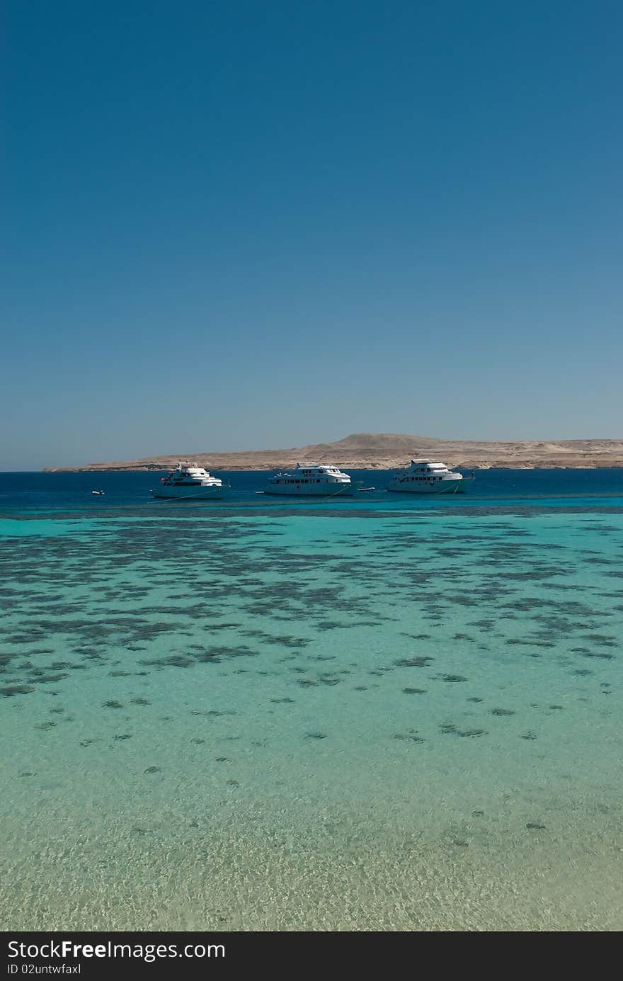 Tropical Lagoon Woth Boats On The Horizon