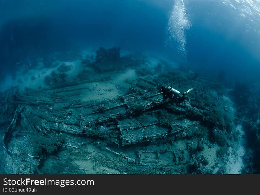 Diver over Underwater wreckage