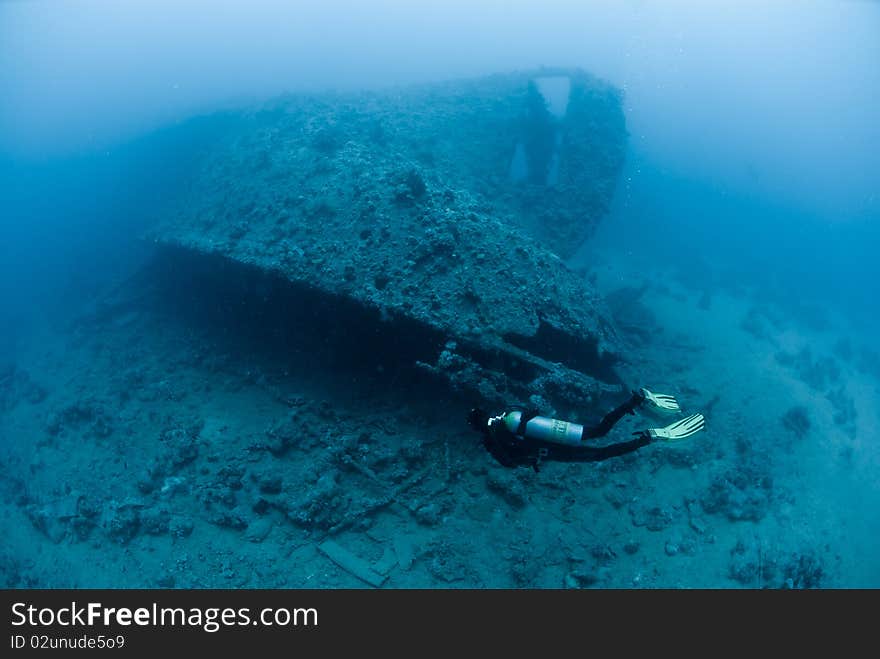 Female scuba diver exploring ship wreck