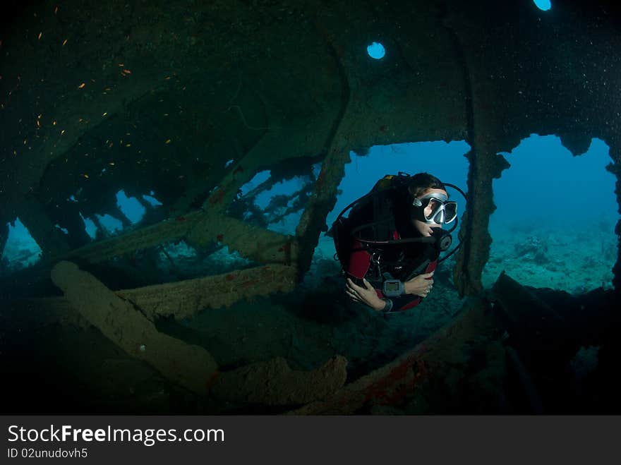 A female scuba diver exploring the inside of the SS Dunraven shipwreck. Beacon rock, Ras Mohammed national Park, Red Sea, Egypt. A female scuba diver exploring the inside of the SS Dunraven shipwreck. Beacon rock, Ras Mohammed national Park, Red Sea, Egypt.