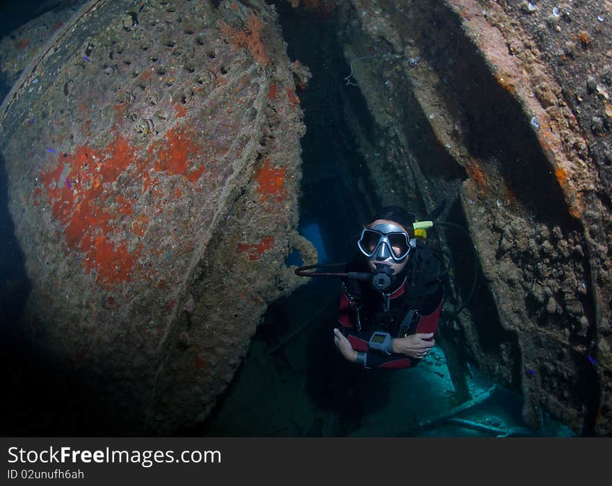 Female Scuba Diver Exploring Ship Wreck