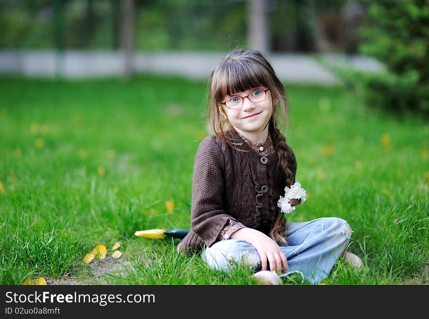 Adorable little girl with beauty blue eyes in glas