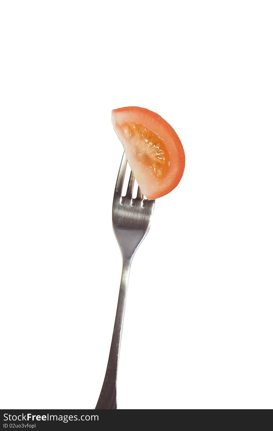 Tomato on fork isolated on white background