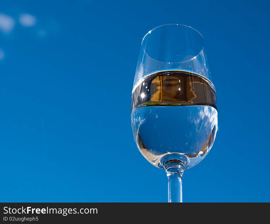 Refreshing glass of pure water against a blue sky. Refreshing glass of pure water against a blue sky