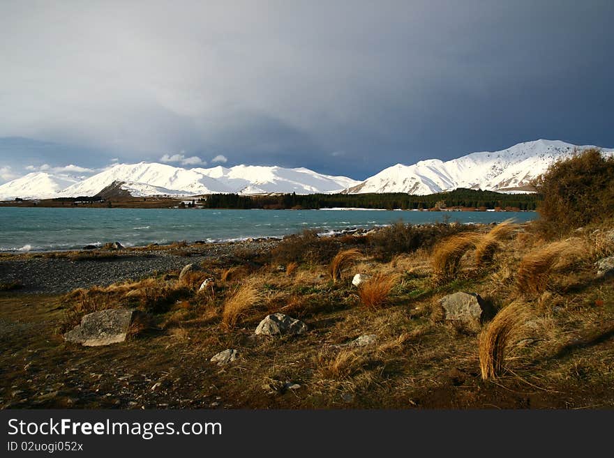 The spectacular view of Lake Tekapo, New Zealand, in winter with the snow mountain backdrop. The spectacular view of Lake Tekapo, New Zealand, in winter with the snow mountain backdrop.