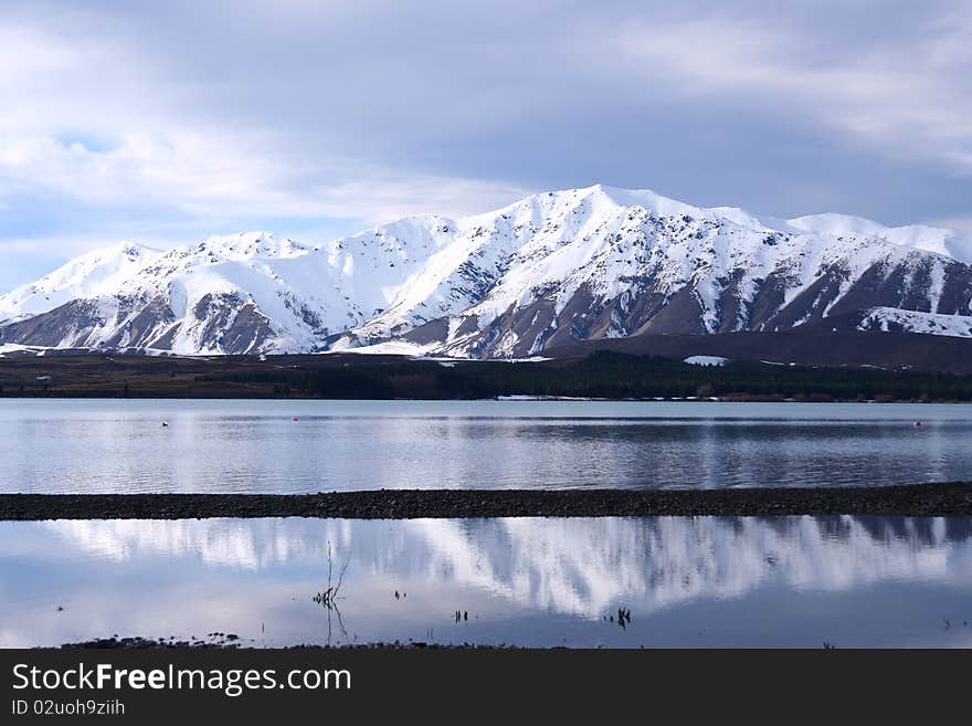 The spectacular view of Lake Tekapo, New Zealand, in winter with the snow mountain backdrop. The spectacular view of Lake Tekapo, New Zealand, in winter with the snow mountain backdrop.