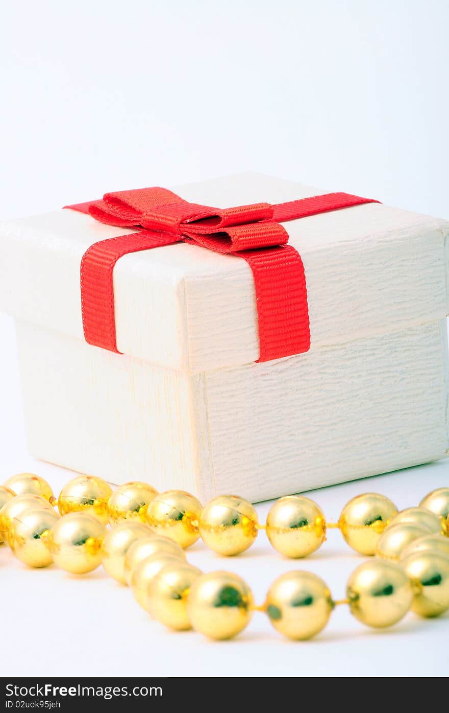 A white gift box with red ribbon