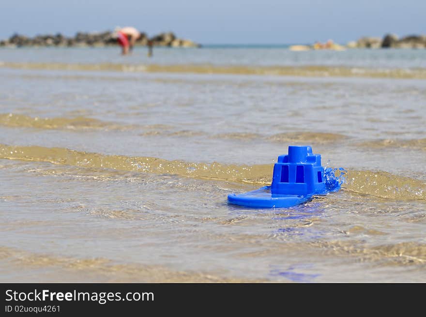 Small boat made of blue plastic in the sea. Small boat made of blue plastic in the sea