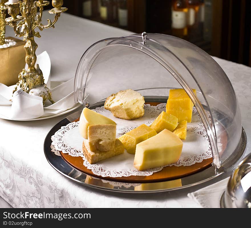 Set of cheese in a bowl for storage on the background of the restaurant. Set of cheese in a bowl for storage on the background of the restaurant