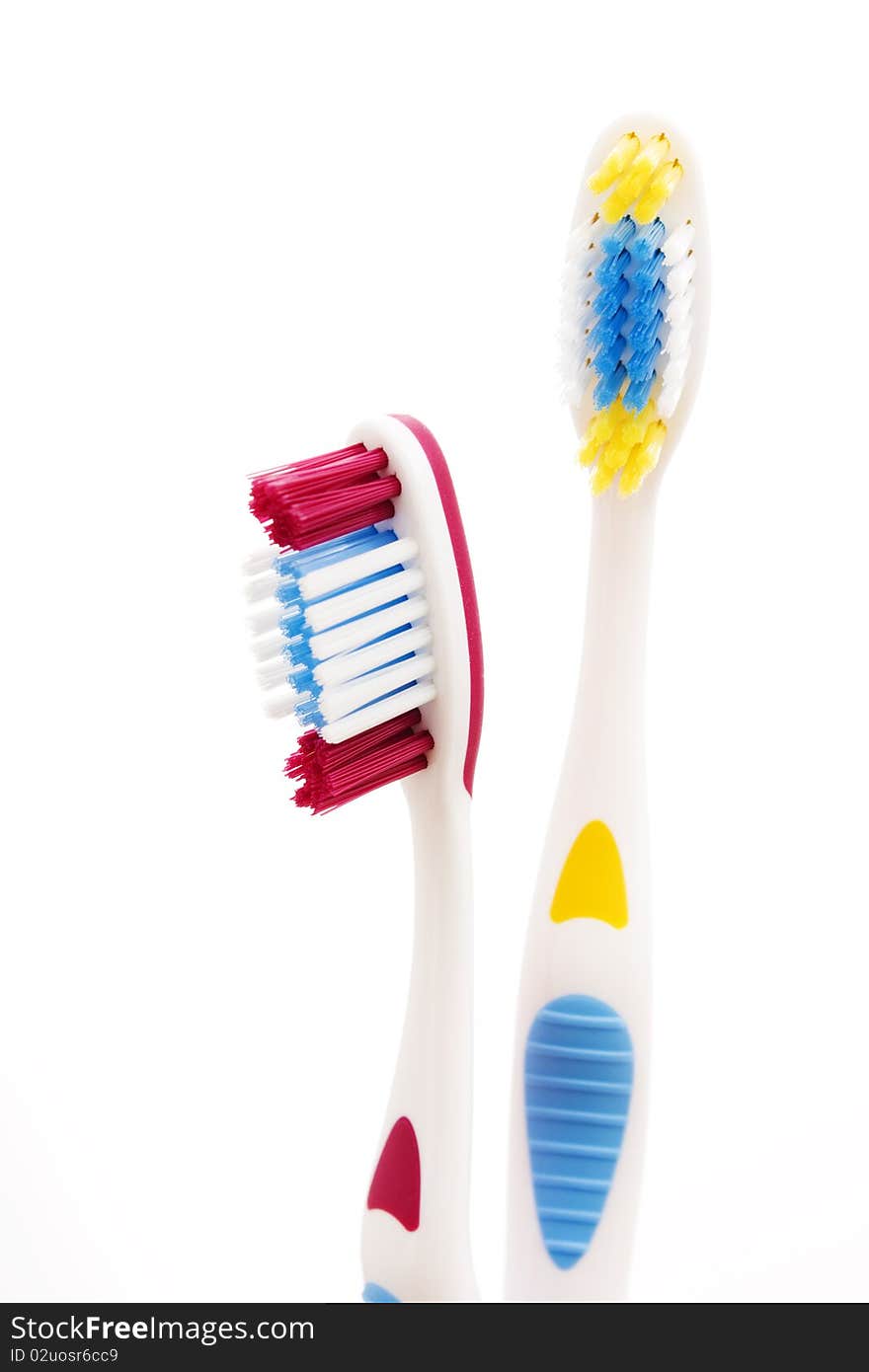 Red and yellow toothbrushes isolated on white