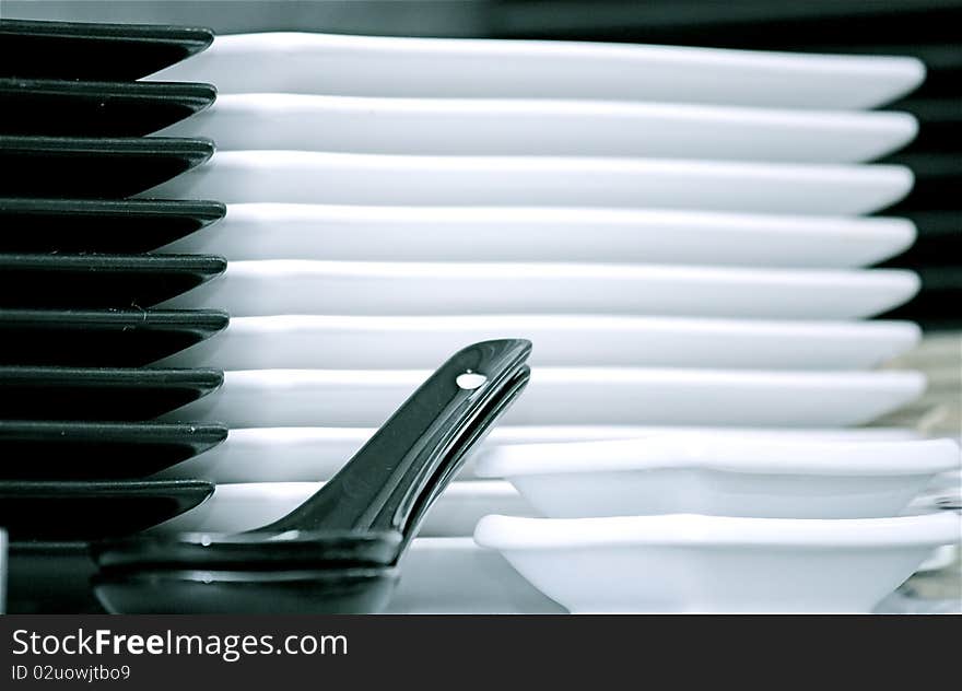 Stack of white and black plates. Stack of white and black plates