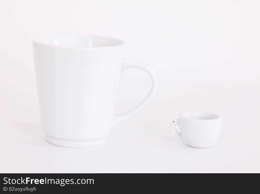 Big and small white cups over blank background