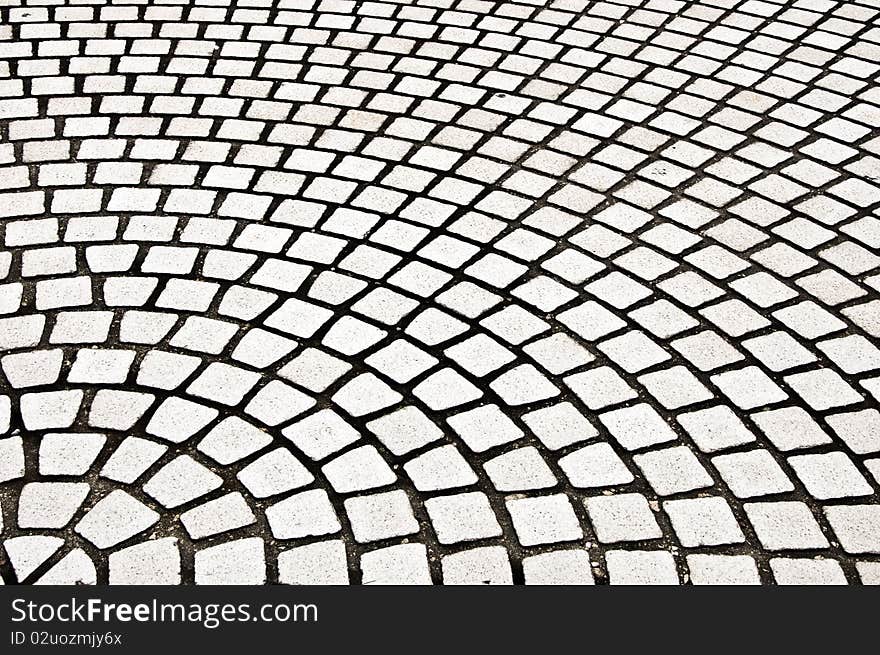 Detail of gray cobblestone forming a pattern