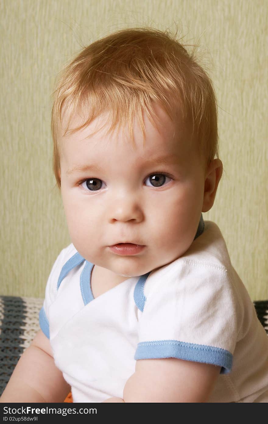 Portrait of little cute baby-boy with grey eyes