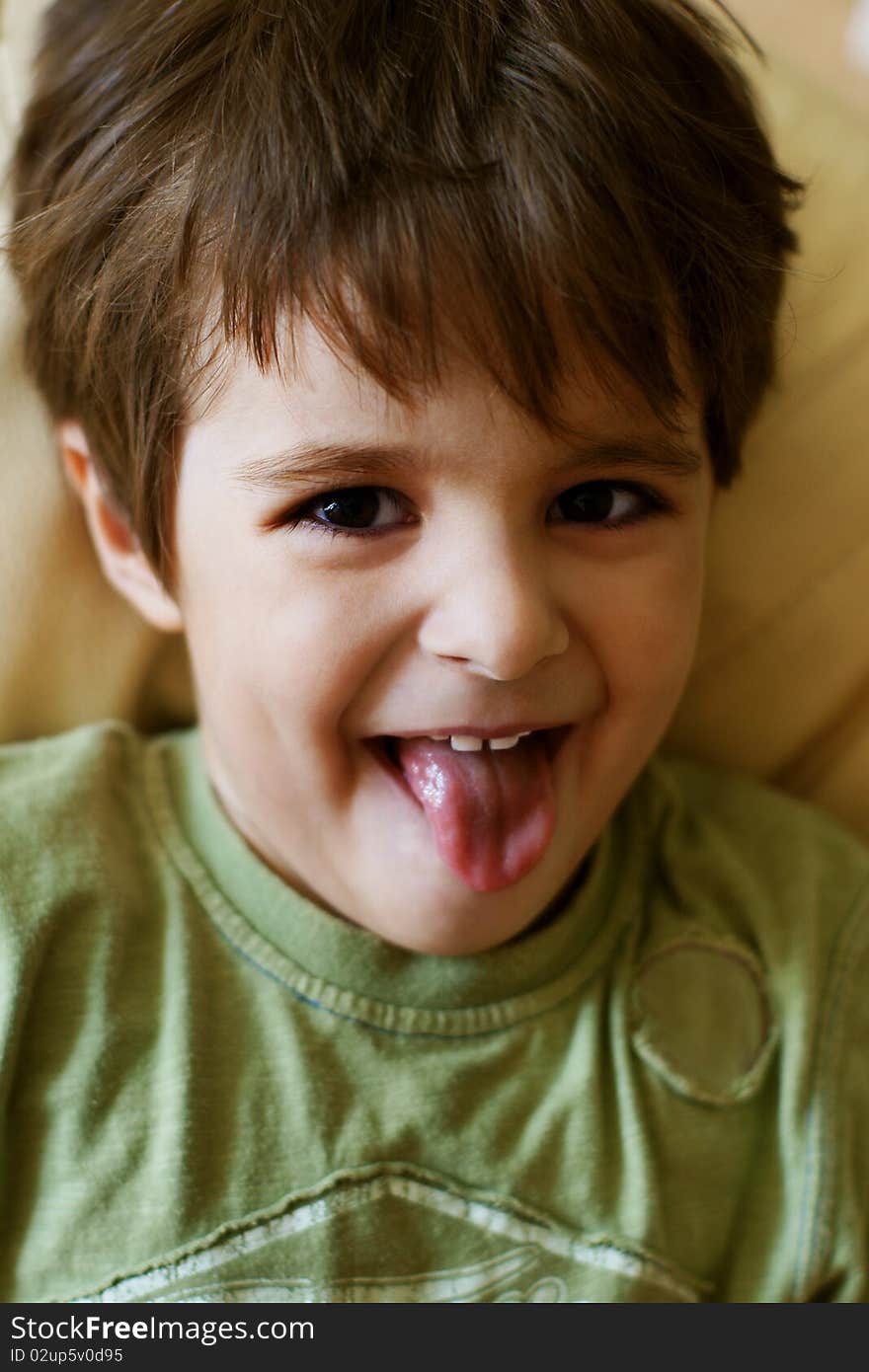 Portrait of playful little boy showing his tongue. Portrait of playful little boy showing his tongue