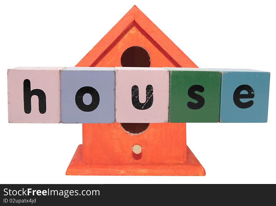 Birdhouse in toy blocks on white