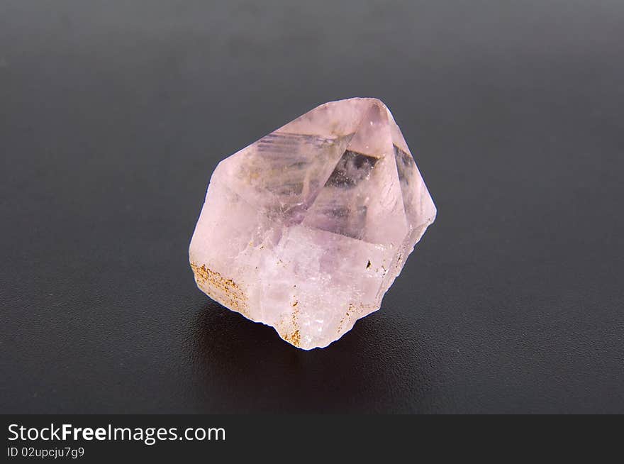 Large amethyst crystal on a gray background