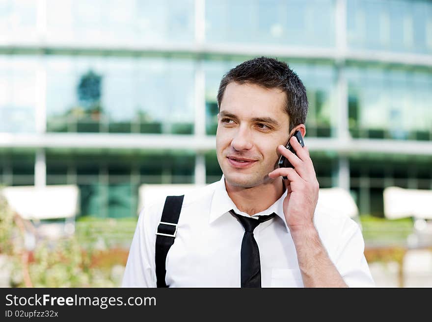 Manager speak on phone across office building