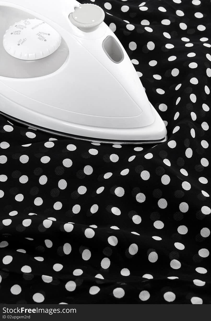 Ironing delicate black and white silky fabric. Ironing delicate black and white silky fabric.