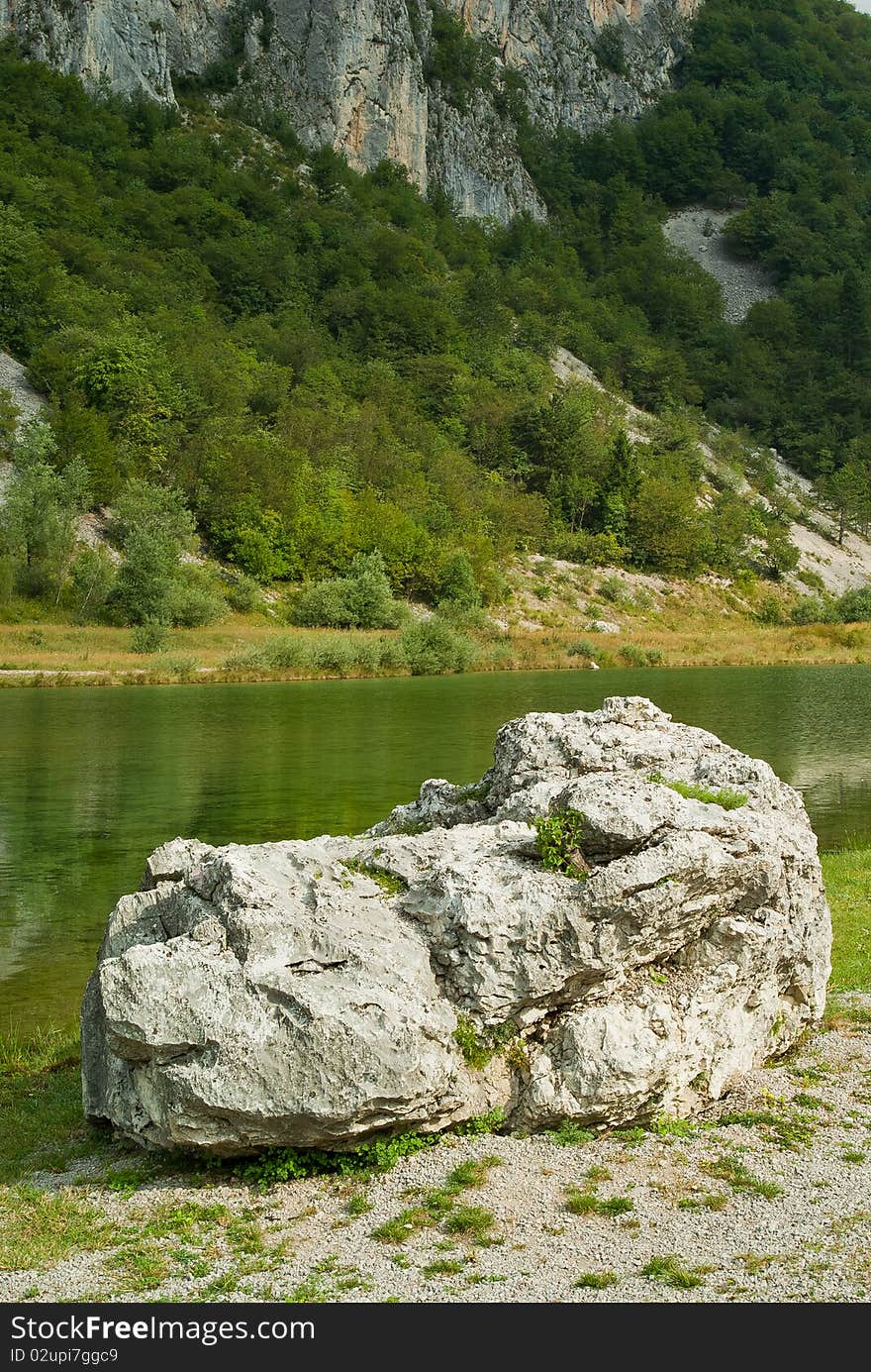 A beautiful park at the foot of a mountain in summer, with a natural lake. A beautiful park at the foot of a mountain in summer, with a natural lake