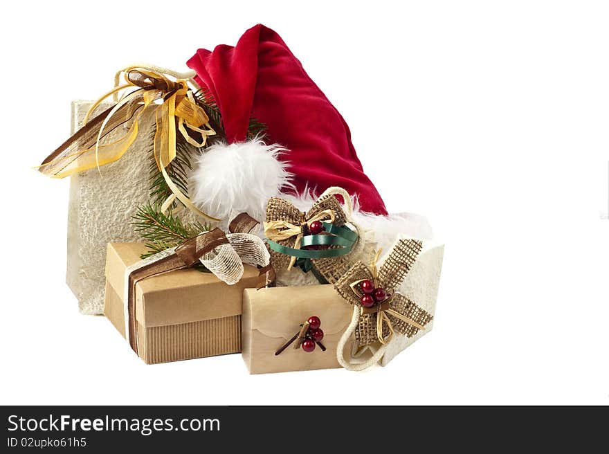 Hat of Santa Claus and gifts on white background