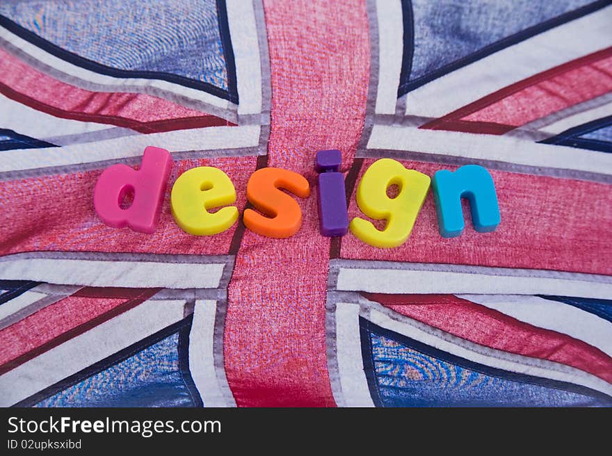 An image of the word 'design' in colorful lower case letters on the Union Jack flag as backdrop. This is a concept image of 'designed in Britain' or 'British by design'. An image of the word 'design' in colorful lower case letters on the Union Jack flag as backdrop. This is a concept image of 'designed in Britain' or 'British by design'.