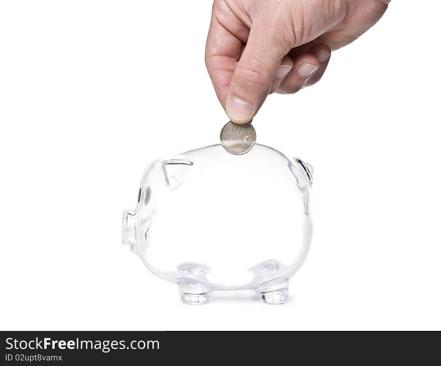 Hand inserting coin into piggy bank. Hand inserting coin into piggy bank