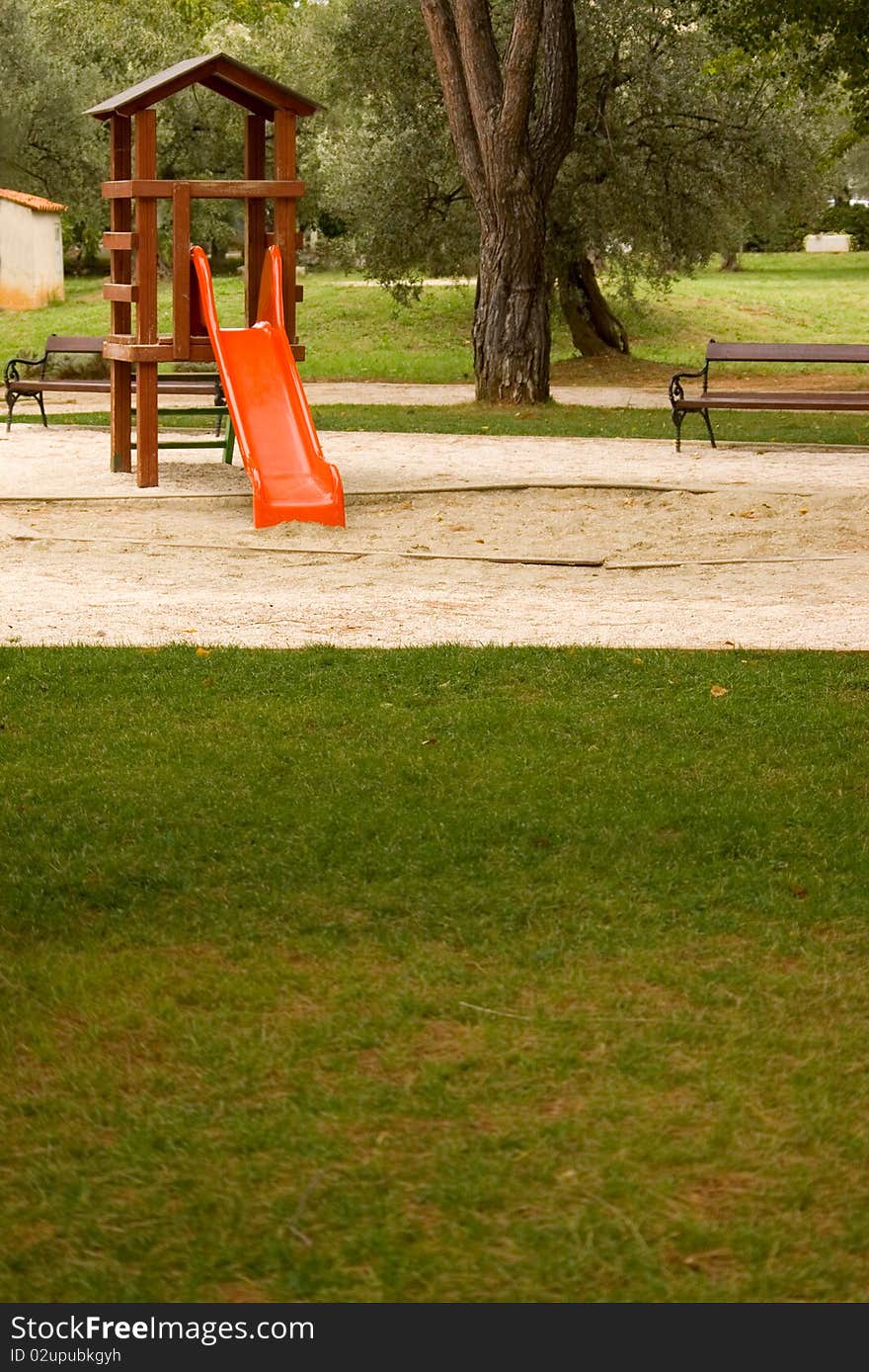 Playground in a park with green grass at front. Playground in a park with green grass at front