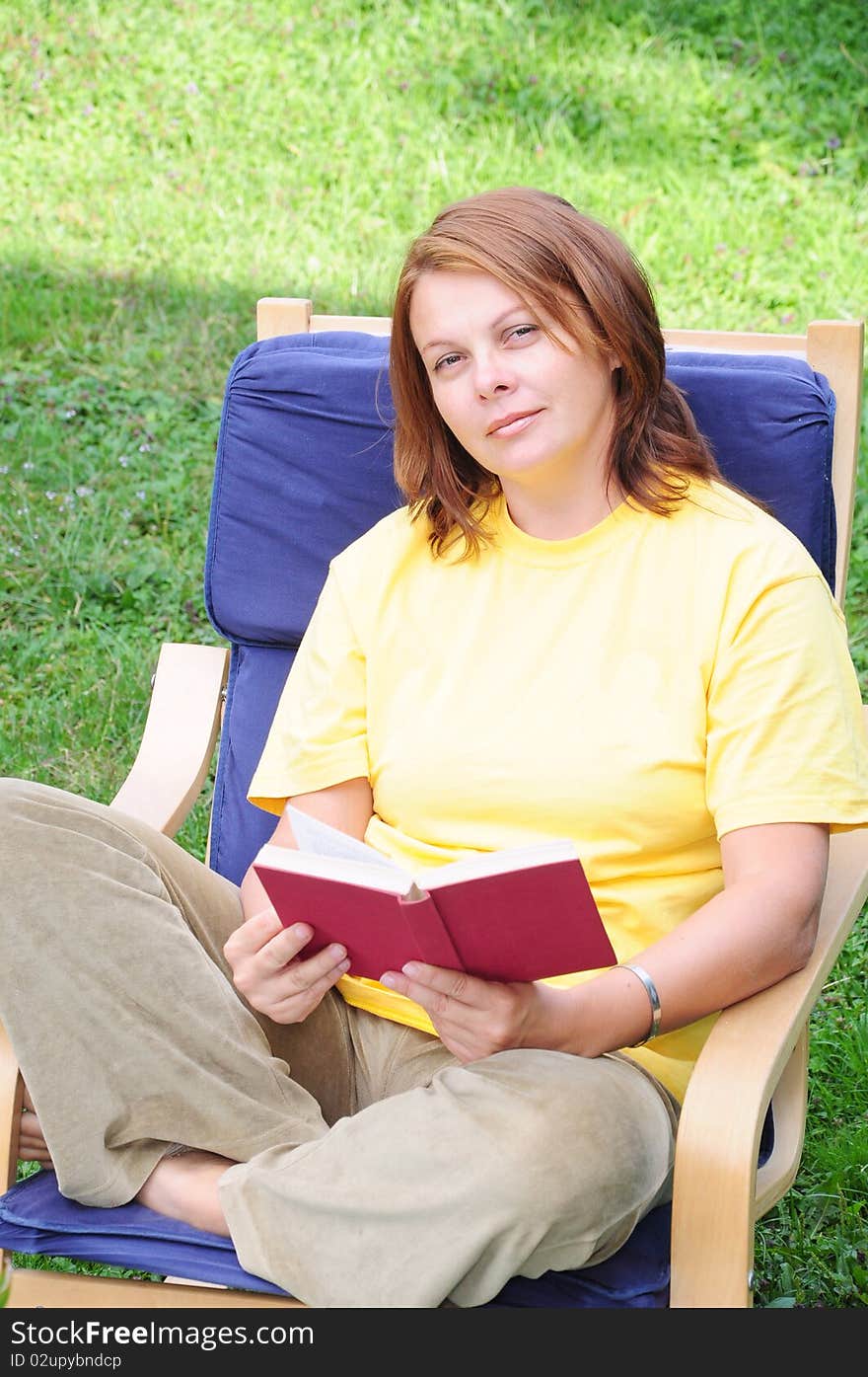 A woman reads a book to relax. A woman reads a book to relax