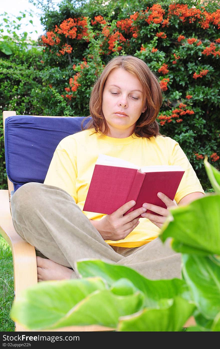 A woman reads a book to relax. A woman reads a book to relax