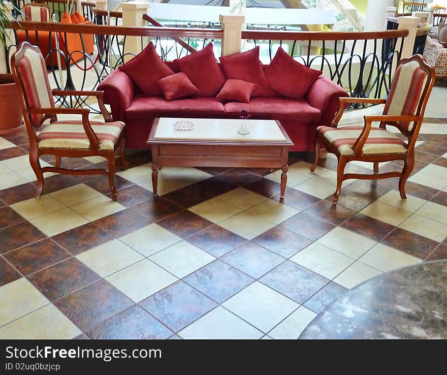 Sofa with chairs in a big hall of a hotel. Sofa with chairs in a big hall of a hotel