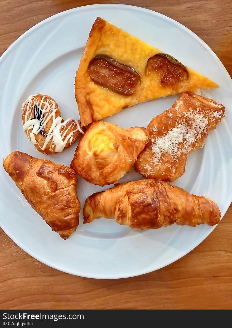 Six different cakes on the plate for breakfast