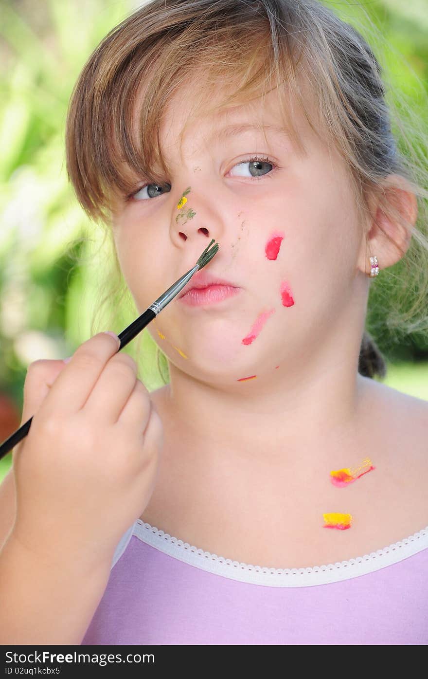 A Child Playing With Colors