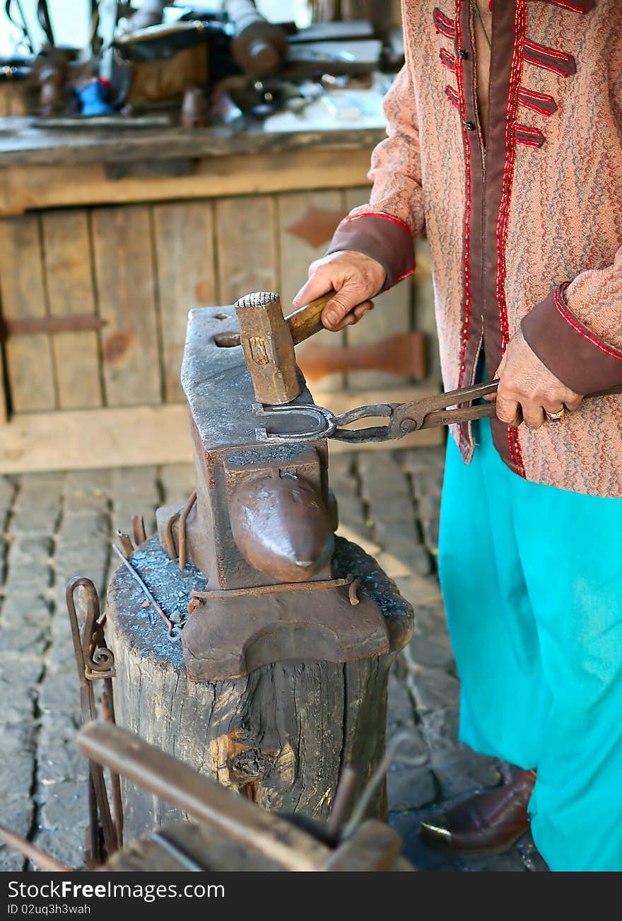 Blacksmith works with horseshoe the blacksmith forge. Blacksmith works with horseshoe the blacksmith forge