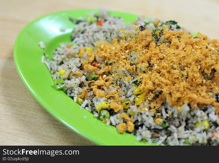 Asian vegetable olive fried rice with pork floss topping. Suitable for concepts such as diet and nutrition, healthy lifestyle, and food and beverage.