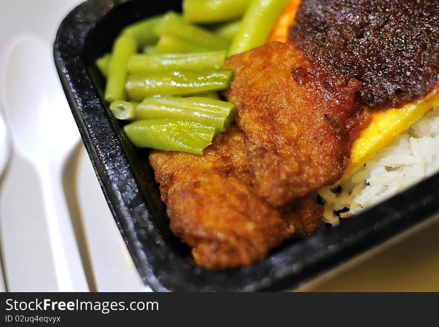 Malay rice set meal with fried fish cutlets. Concepts such as food and beverage, and travel and cuisine, and health and nutrition.