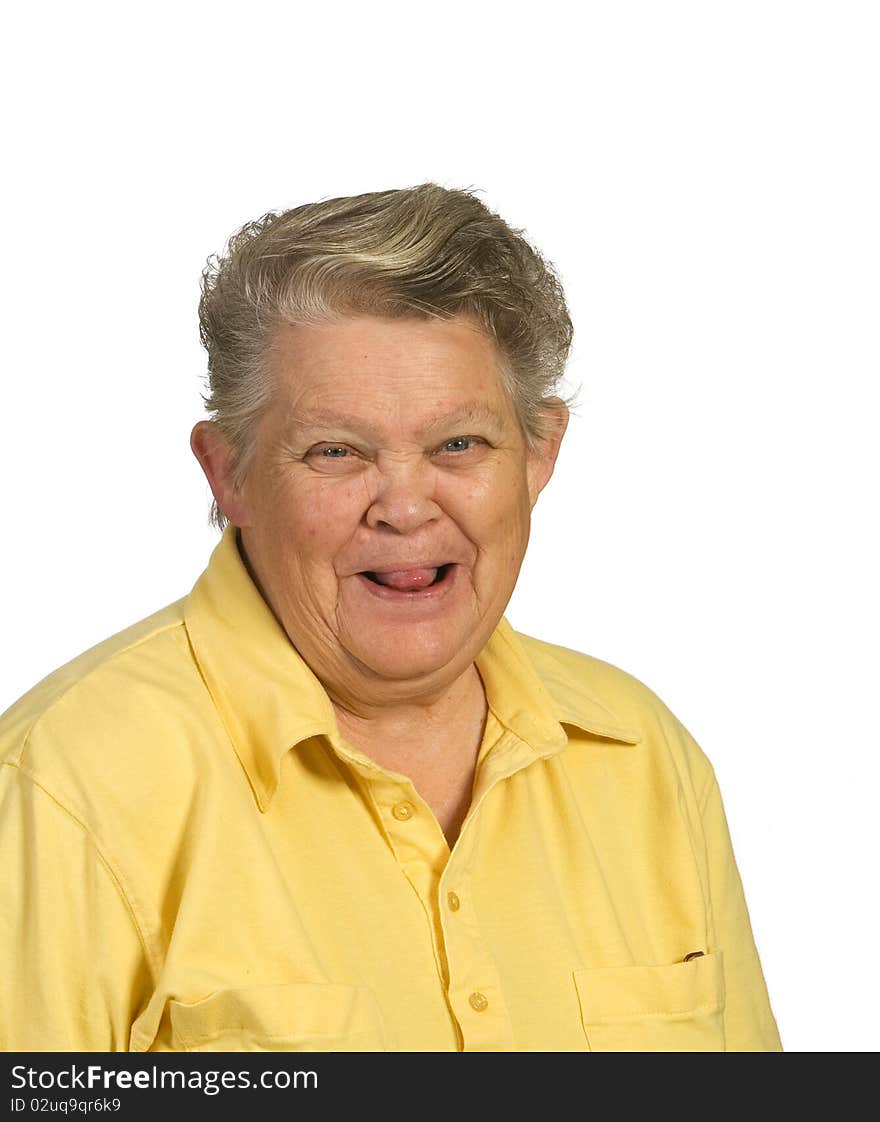 Playful senior woman sticking tongue out. Shot against a white background