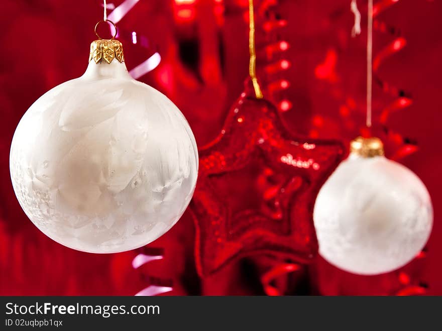 Beautiful christmas star and white baubles on red background