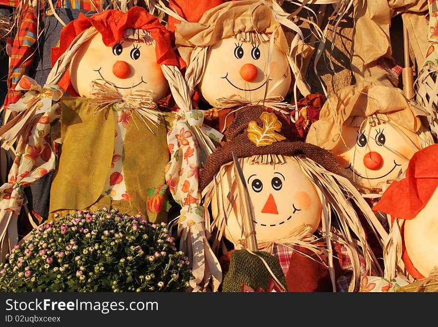 Four adorable scarecrows with fall flowers. Four adorable scarecrows with fall flowers.