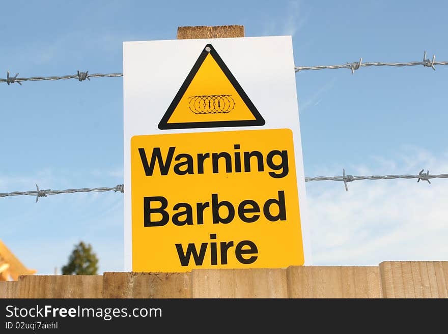 Image of a barbed wire warning sign at a construction site