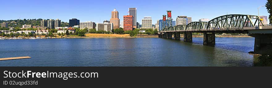 A panoramic view of the city skyline and the Hawthorne bridge overseeing the western hills. A panoramic view of the city skyline and the Hawthorne bridge overseeing the western hills.